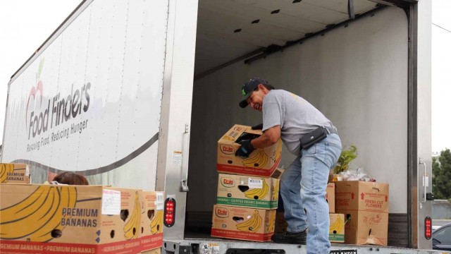 Juan, a Food Finders food rescue driver, loads donated surplus food into a Food Finders truck during a scheduled food rescue.